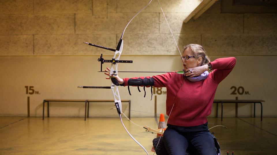 Woman in wheelchair holding a bow