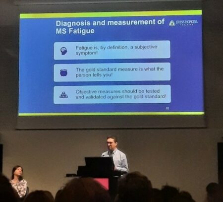 Dr. Bardia Nourbakhsh's slide display at a large screen: People with MS are the ‘goldest’ standard to share their symptoms